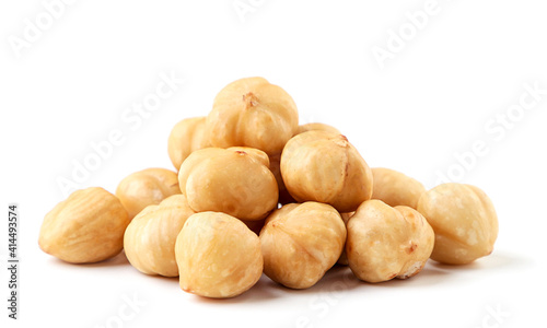 Heap of roasted hazelnuts on a white background. Isolated