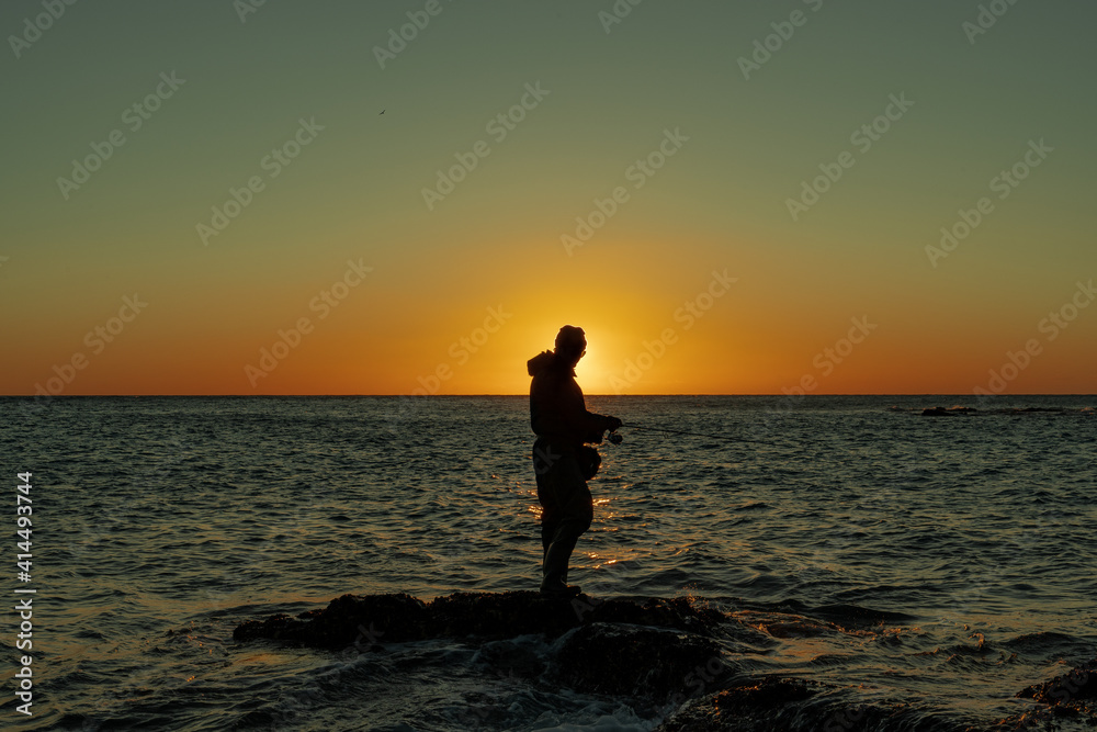 Man fishing on sunset