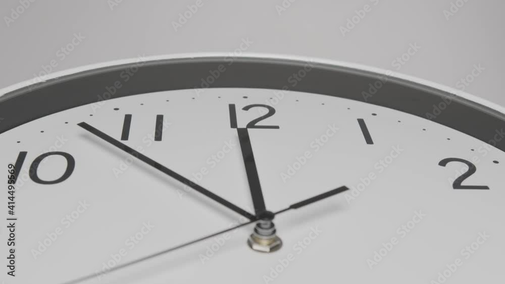 Wall clock on white background Startime 11.50 am, Time lapse 20 minutes. Wall clock on white background Startime 11.50 am, Time lapse 20 minutes.