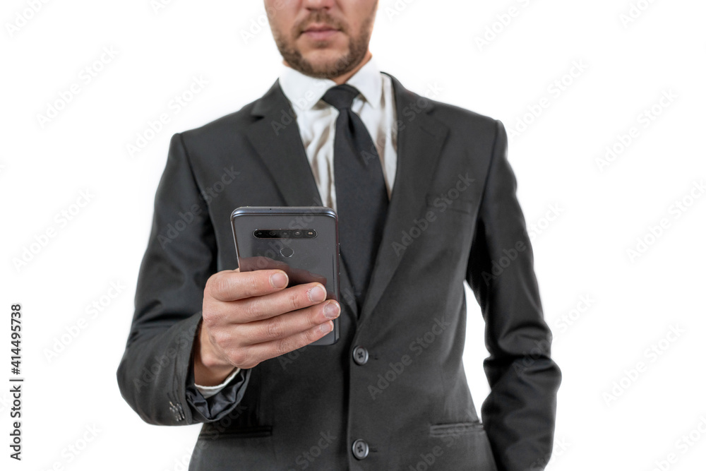 Side view of a businessman in formal clothing looking at his smartphone Side view of a businessman in formal clothing looking at his smartphone