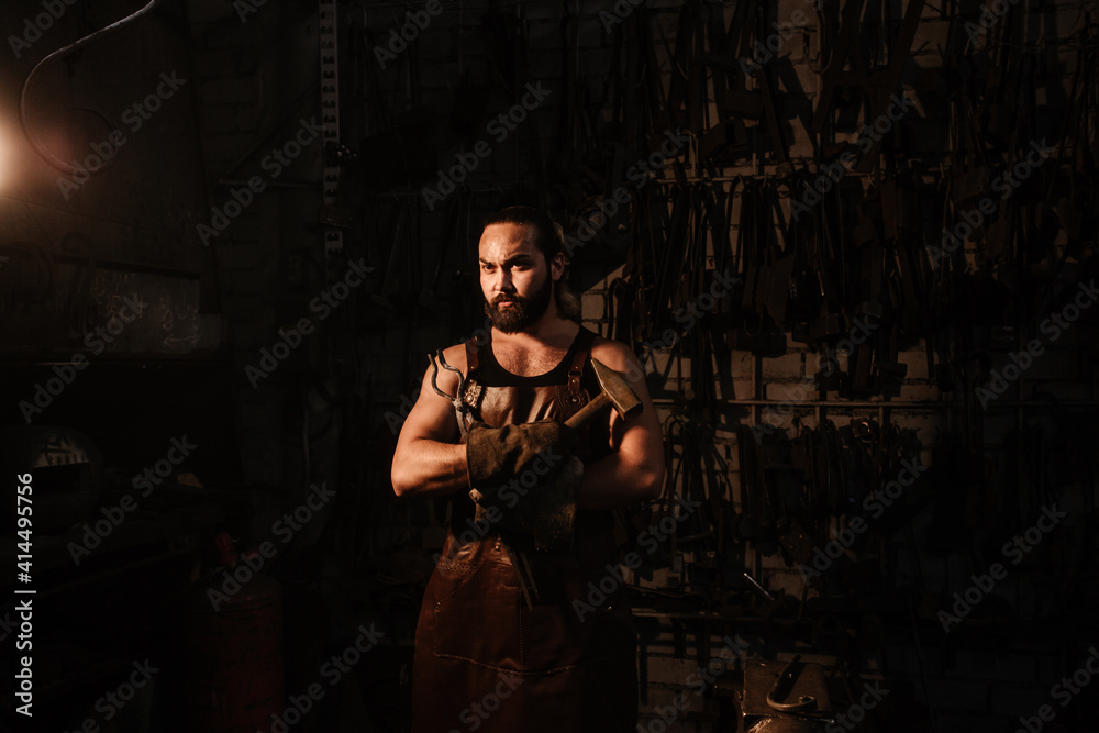 Portrait of a blacksmith in a blacksmith shop