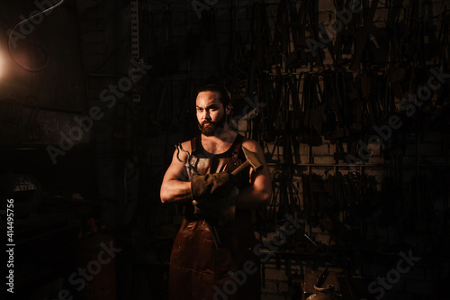 Portrait of a blacksmith in a blacksmith shop