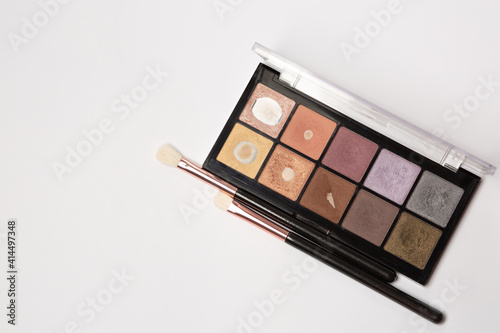Closeup shot of eyeshadow palette with brushes