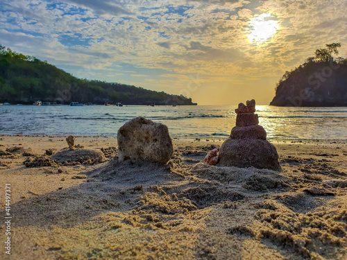 Little sand castles made by children in the cystal beach of Nusa Penida island of bali, Indonesia photo