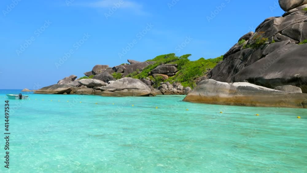 Blue Ocean Beach with Big Rocks, Crystal Clear Turquoise Water and Greenery Near Tropical Island. Amazing Landscape with Azure Water and Blue Sky on Background on Famous Similan Islands, Thailand