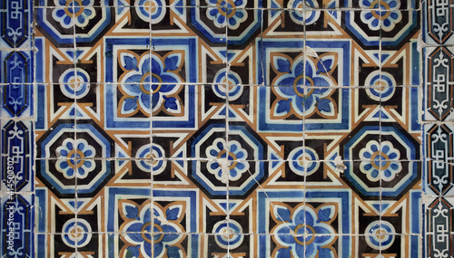 Details of ancient tiles with geometrical shapes  covering facades of buildings in Lisbon. Typical sample of traditional Portuguese craft.