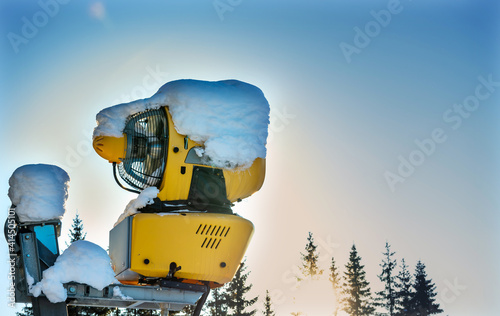 Snow making machine at a ski resort on a sunny winters day.