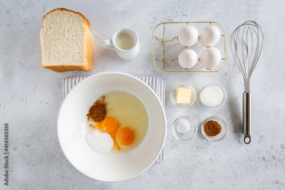 Flay lay of ingredients for making french toast (or wentelteefjes in Dutch) on white grey background. view from above Flay lay of ingredients for making french toast (or wentelteefjes in Dutch) on white grey background. view from above