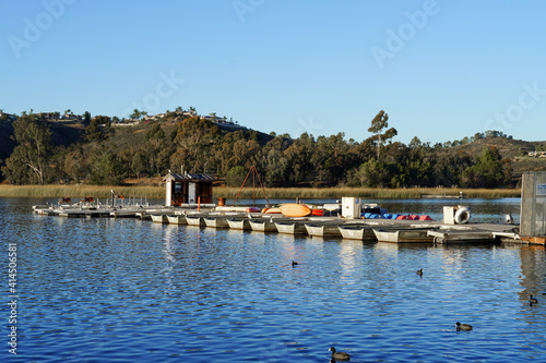 Wood pier with pedal boat and small boat. Miramare Lake, San Diego, California, USA. 