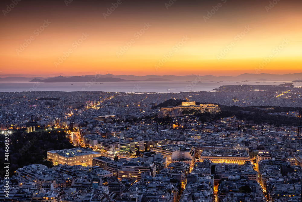 View over the illuminated skyline of Athens, Greece, with Parthenon Temple and the Acropolis and the busy streets around Syntagma Square during dusk