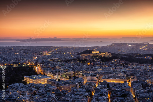 Fototapeta Naklejka Na Ścianę i Meble -  View over the illuminated skyline of Athens, Greece, with Parthenon Temple and the Acropolis and the busy streets around Syntagma Square during dusk