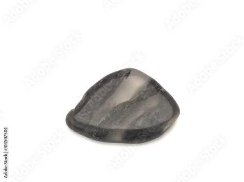 macro shooting of natural stone - black quartz mineral gem stone interspersed with organic matter isolated on a white background