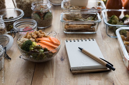 Tableau sur toile Batch cooking scene with an empty spiral menu notebook.