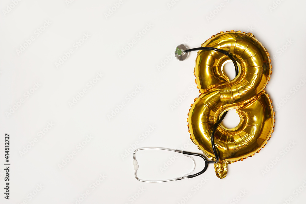 Stethoscope and ballon number eight 8 on white background. Doctor's day and World health day. Creative medical background, postcard. Top view, flat lay, copy space. Stethoscope and ballon number eight 8 on white background. Doctor's day and World health day. Creative medical background, postcard. Top view, flat lay, copy space.