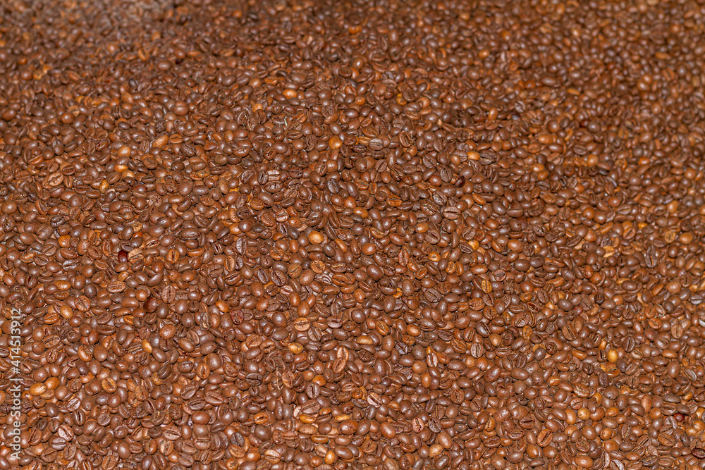 Roasted coffee beans of the Robusta variety that can be used as a wallpaper or texture for publications.
