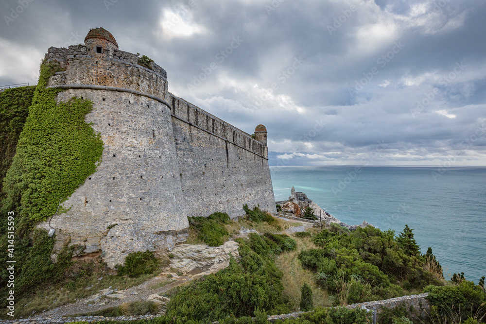 Beautiful views of Porto Venere: Doria Castle (12th century) with The church of Saint Peter and blue seascape in background