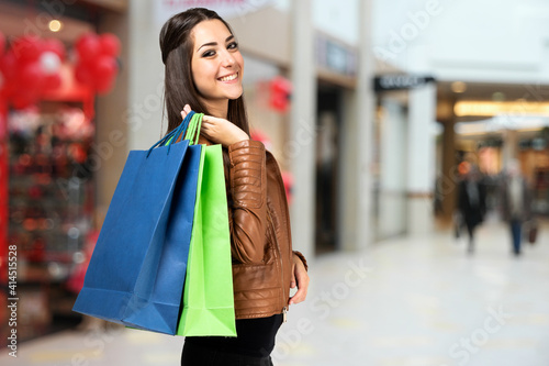 Young woman holding shopping bags in a shopping mall