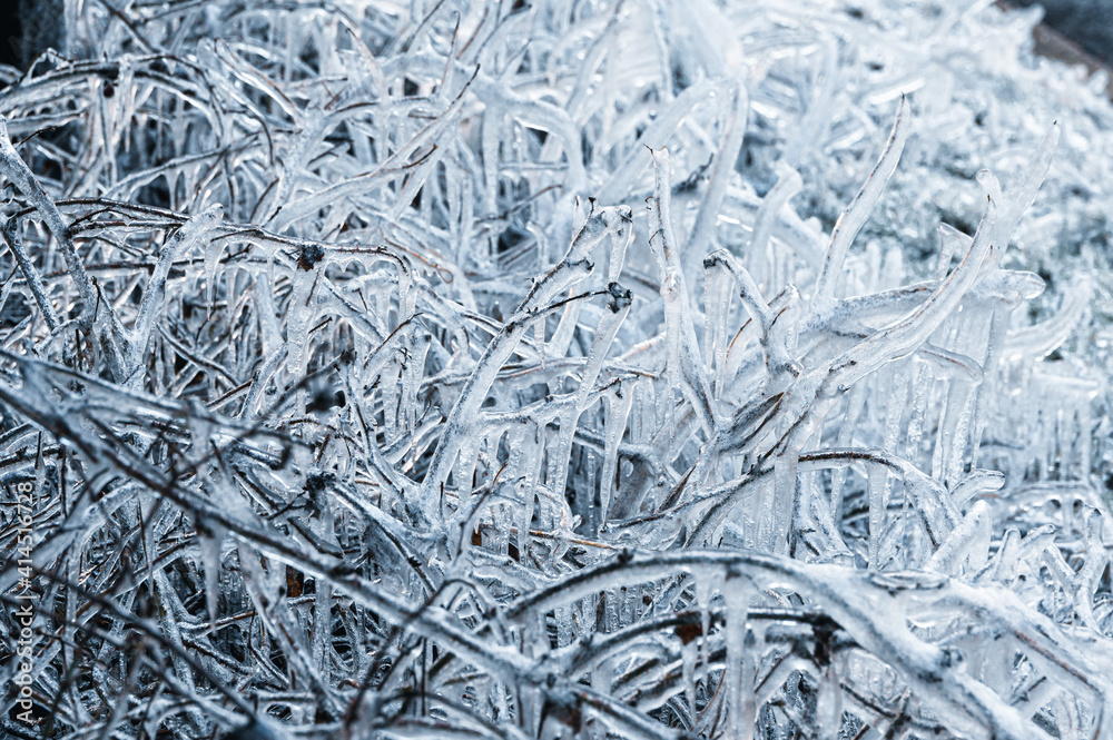 UK weather with icicles formed from splashed road water