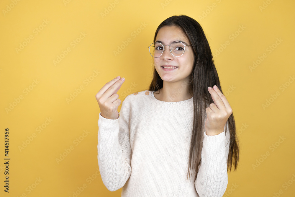 Beautiful child girl wearing casual clothes doing money gesture with hands, asking for salary payment, millionaire business Beautiful child girl wearing casual clothes doing money gesture with hands, asking for salary payment, millionaire business