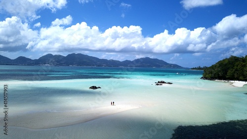 aerial view from Saint-Anne Marine National Park over white sandbars, blue sea to Mahe Island