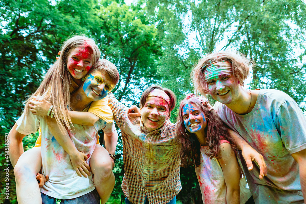 young happy friends at holi fest