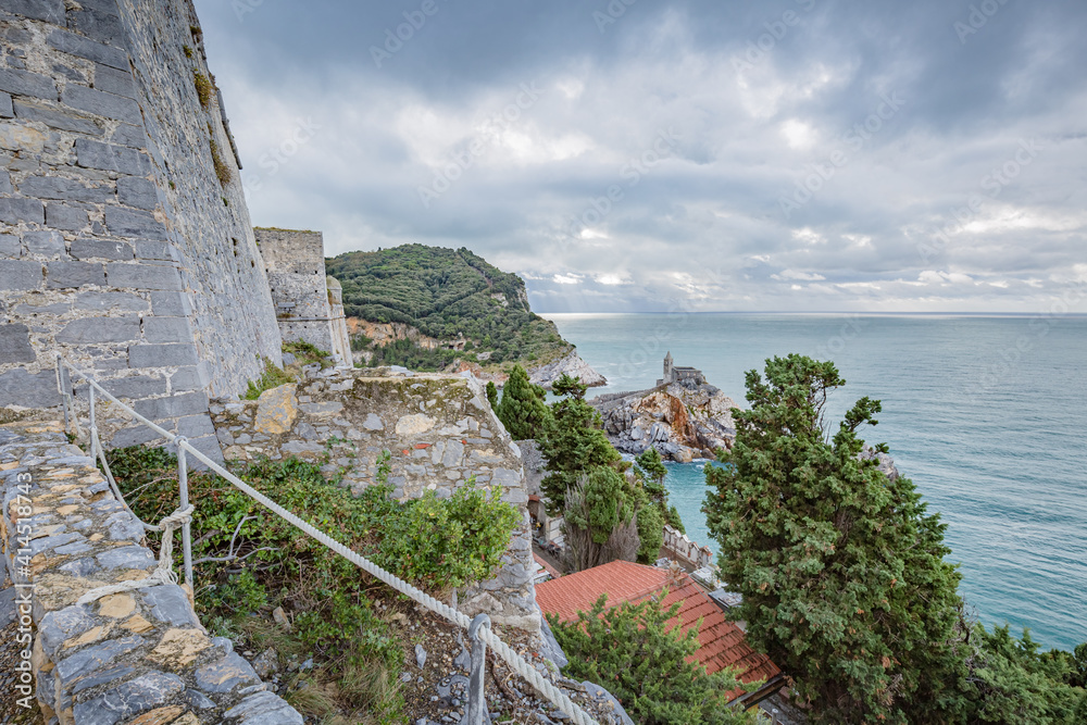 Beautiful views of Porto Venere: Doria Castle (12th century) walls with The church of Saint Peter and seascape in background