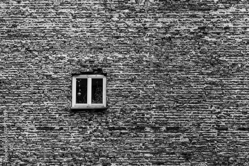 lone window in brick wall of the building