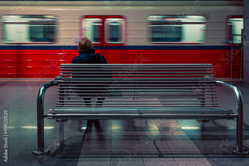 Obraz na plátně woman sitting on the bench on metro station