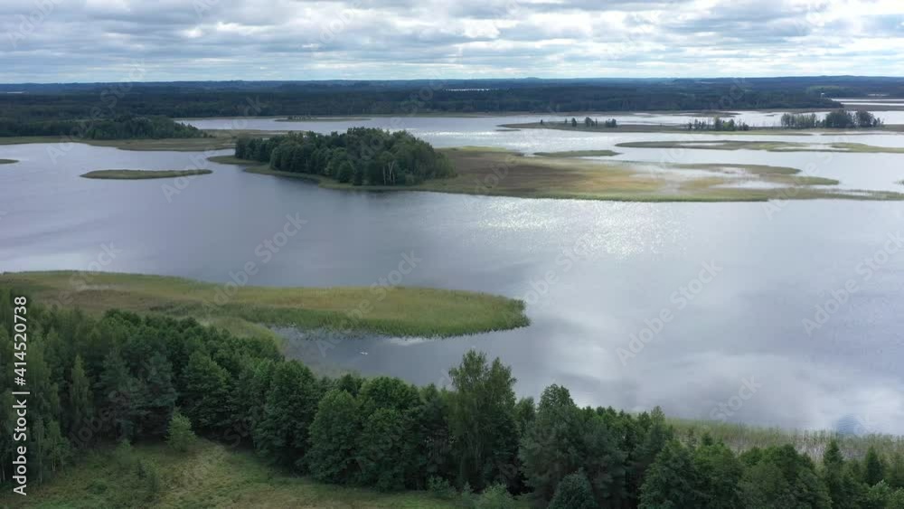 Aerial view at Braslav lakes in National Park. Blue beautiful water. Drone flies over incredible landscape in national park Popular tourist place in Belarus. Aerial view at Braslav lakes in National Park. Blue beautiful water. Drone flies over incredible landscape in national park Popular tourist place in Belarus.