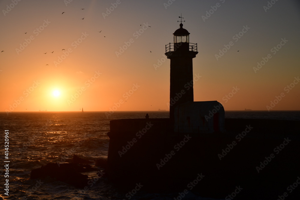 Sunset with a lighthouse in the background