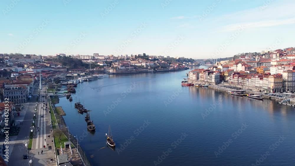 Aerial view of Douro river, Gaia and Porto river banks on a sunny day, drone going backward Aerial view of Douro river, Gaia and Porto river banks on a sunny day, drone going backward