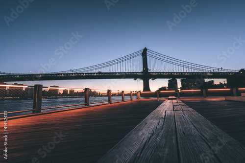 bridge manhattan new york city seat wood panorama pier sunrise sky lights horizon buildings 