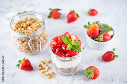 Strawberry Greek yogurt granola parfait in a glass