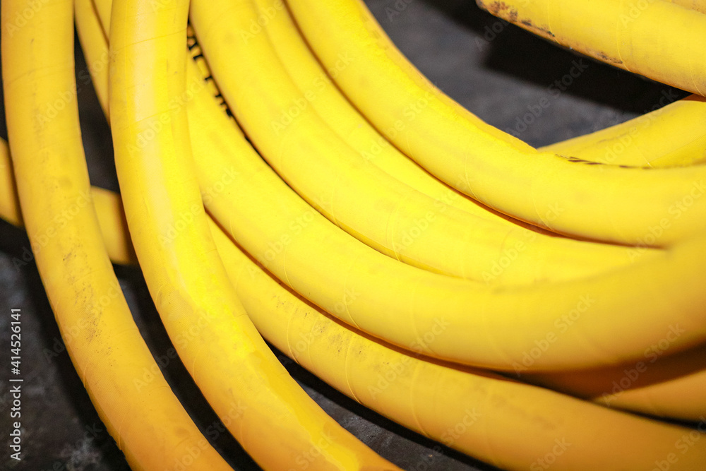 The yellow hose tube is coiled into a bundle.