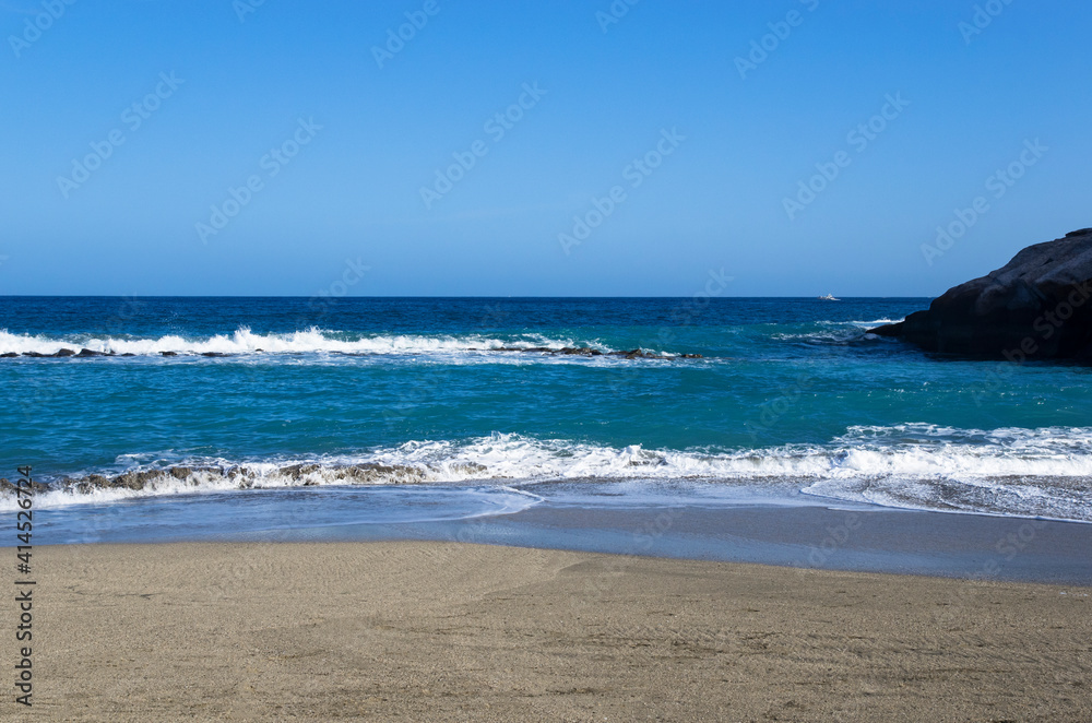 Landscape of the blue sea with a coastline with sand