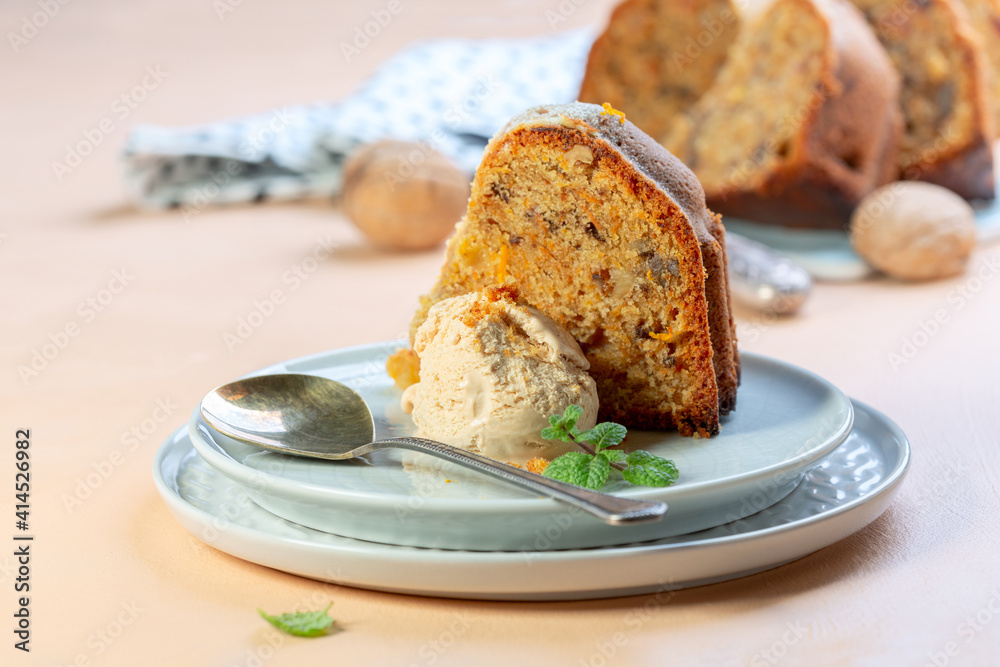 Piece of homemade carrot cake with ice cream.