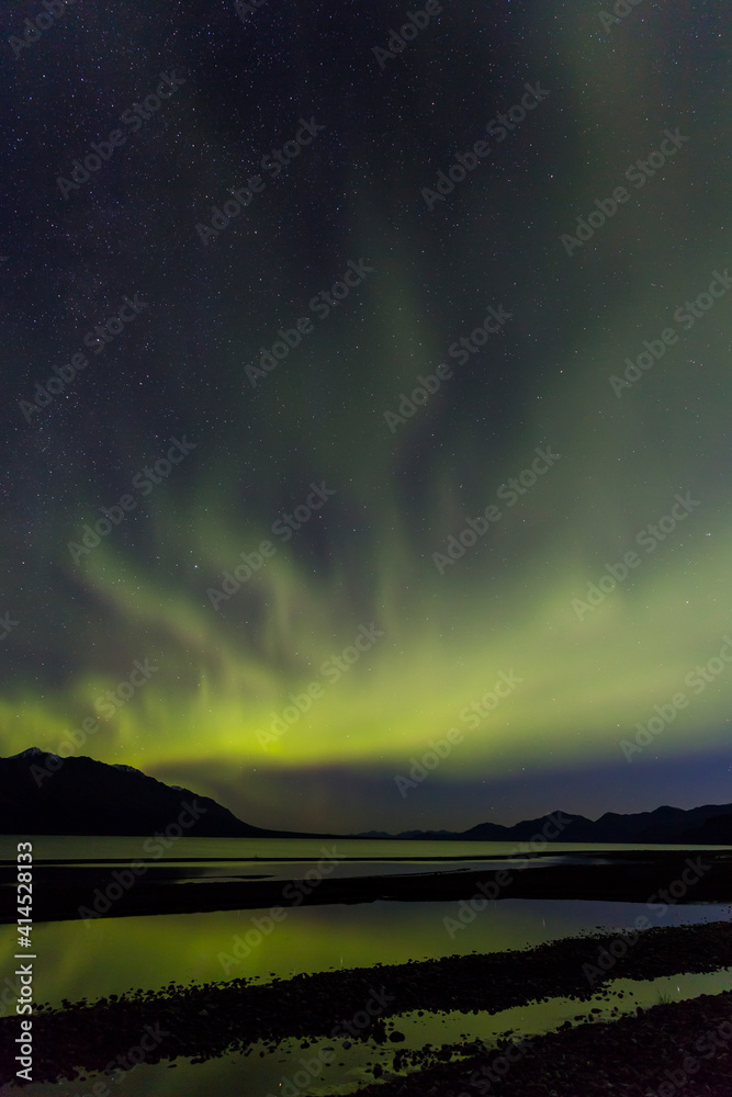 Canada, Yukon Territory, Kluane Lake. Aurora borealis reflects in lake.