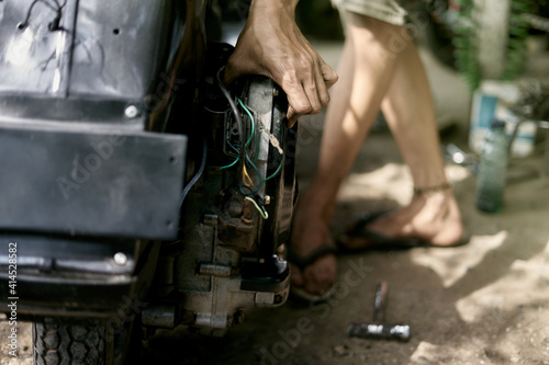 Fototapeta Naklejka Na Ścianę i Meble -  Mechanic repairing retro motorcycle