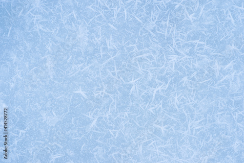 Ice blue with textured white frost on a flat surface. Background