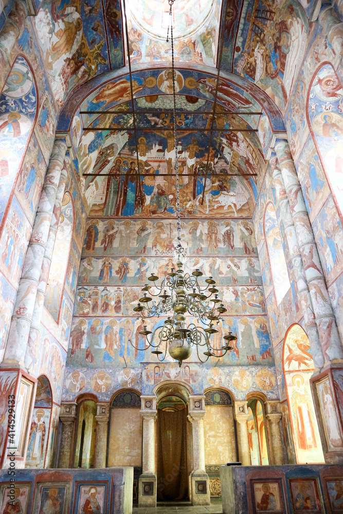 painted ceiling with old chandelier in interior of the orthodox church in Russia