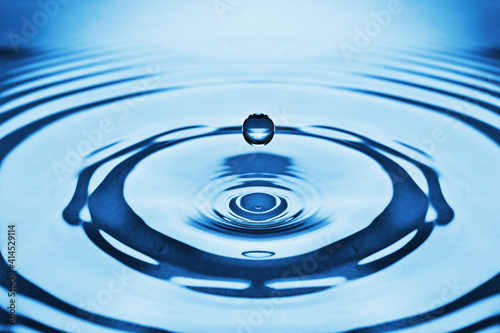The round transparent drop of water, falls downwards...