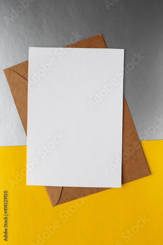 postcard mockup. blank white card with kraft brown paper envelope 