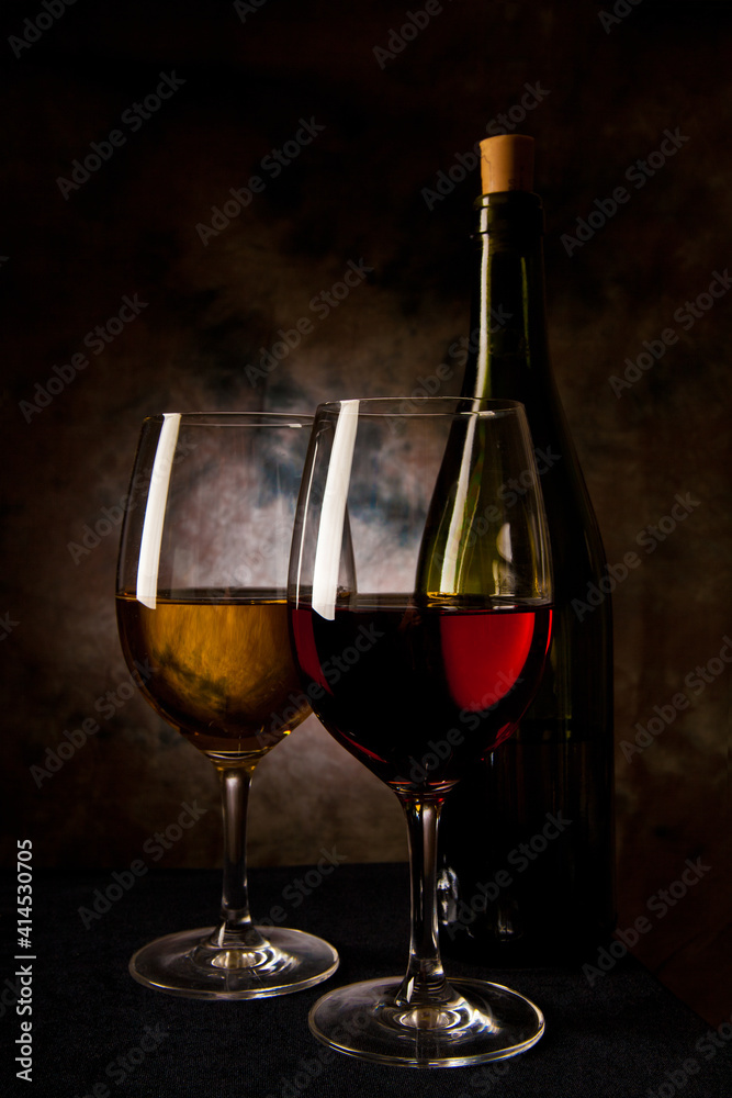 glass with red and white wine at dark