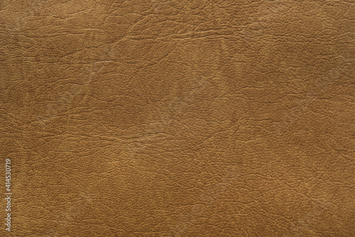 Brown leather texture with light streaks, background.