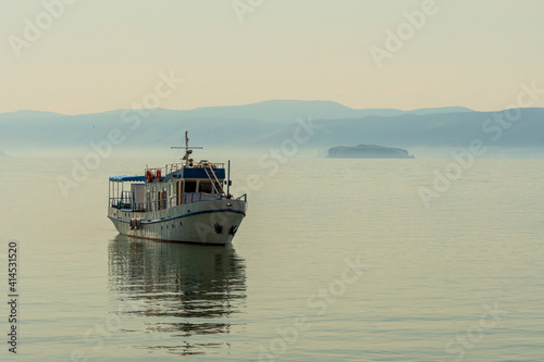 Small transport boat on Lake Baikal at sunset  © Jan