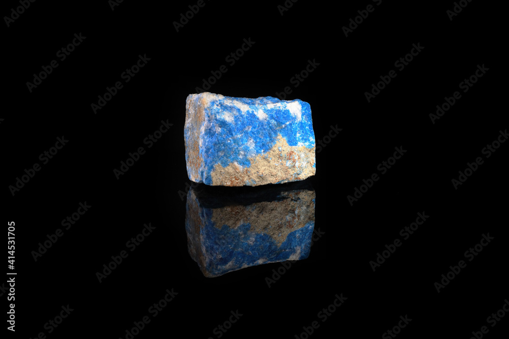 Natural mineral - rough Lazurite, Lapis Lazuli from Pamir, Tajikistan on black glass background. Natural mineral - rough Lazurite, Lapis Lazuli from Pamir, Tajikistan on black glass background.