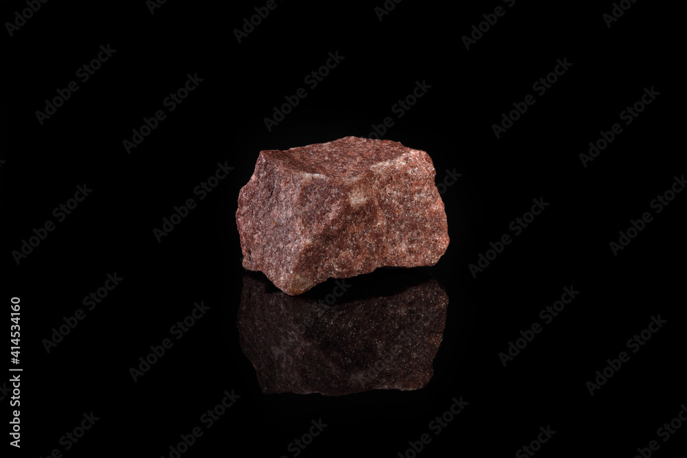 Natural mineral from geological collection - raw pink quartzite stone from Shoksha, Karelia, Russia on black glass background. Natural mineral from geological collection - raw pink quartzite stone from Shoksha, Karelia, Russia on black glass background.