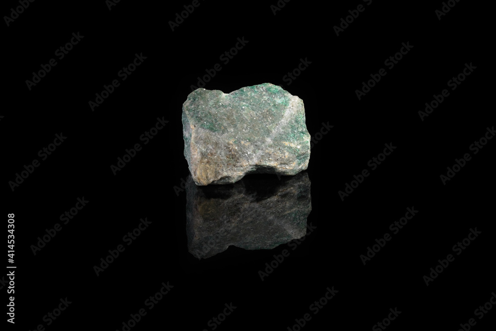 Natural rock specimens - green listvenite, listwanite mineral from Berezovsk, Ural, Russia on black glass background. Natural rock specimens - green listvenite, listwanite mineral from Berezovsk, Ural, Russia on black glass background.