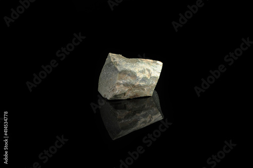 Natural mineral Ophicalcite is a calcified calcite from Satka, Ural, Russia on black glass background. photo