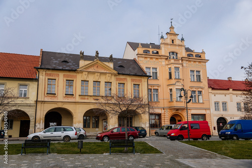Narrow medieval square with baroque and renaissance historical buildings, cityscape of medieval town in sunny winter day, Benatky nad Jizerou, Central Bohemian, Czech Republic photo